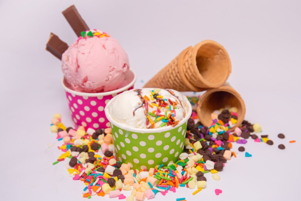 Ice cream and toppings in colorful cups