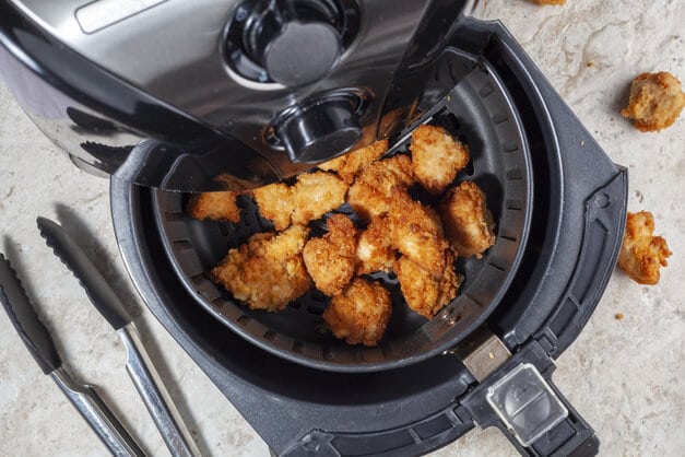 photo of chicken in an air fryer, illustrating a blog about air fryer ideas