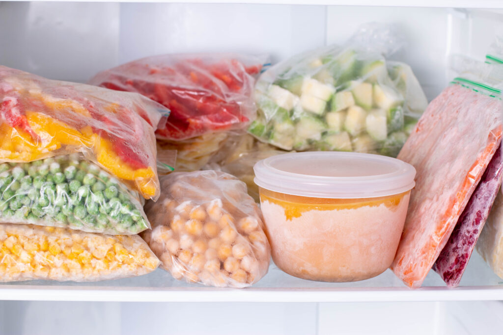 Frozen soups and vegetables packaged inside a freezer