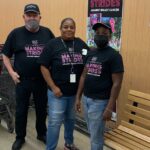 Three people in matching Making Strides Against Breast Cancer T-shirts