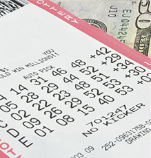 Lottery ticket sitting on top of money