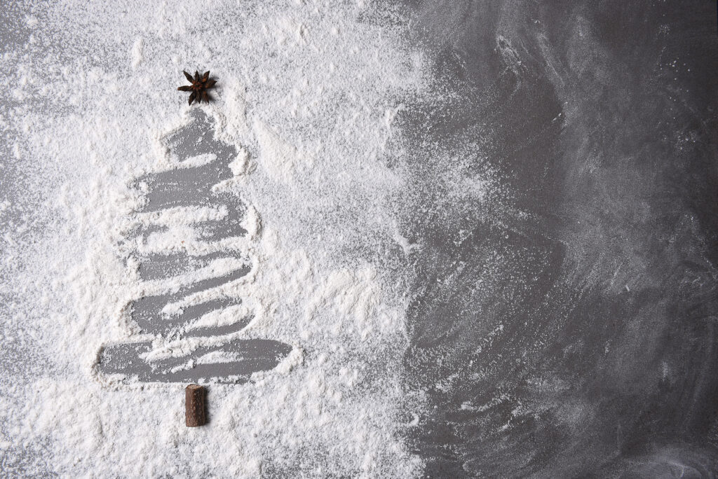 Flour on countertop brushed out in the shape of a Christmas tree