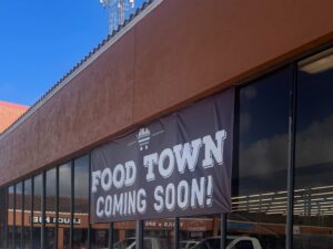 "Food Town Coming Soon" banner hanging over grocery store windows